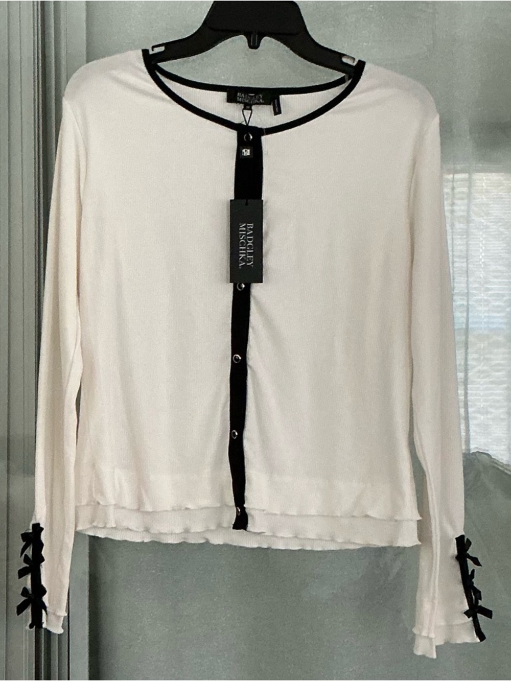 Badgley Mischka white ribbed cardigan featuring black trim